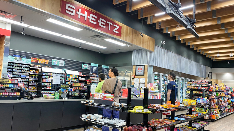 Shoppers line up at a cash register inside a Sheetz