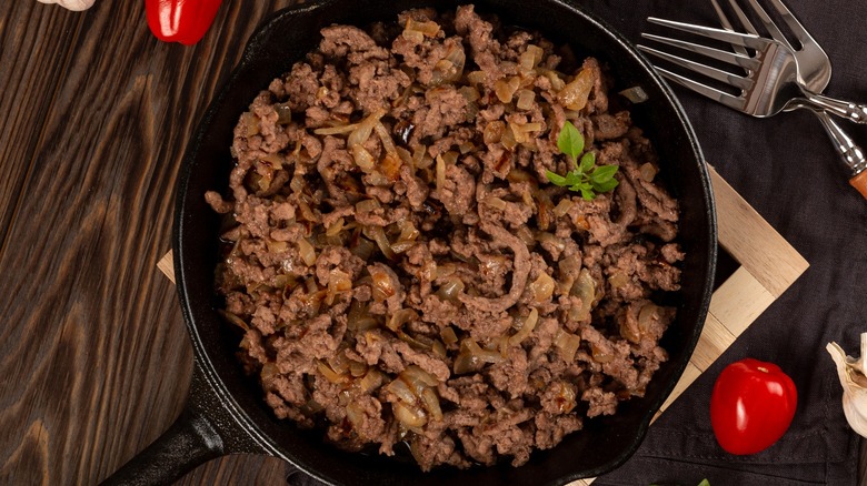 Browned ground beef in a cast-iron skillet