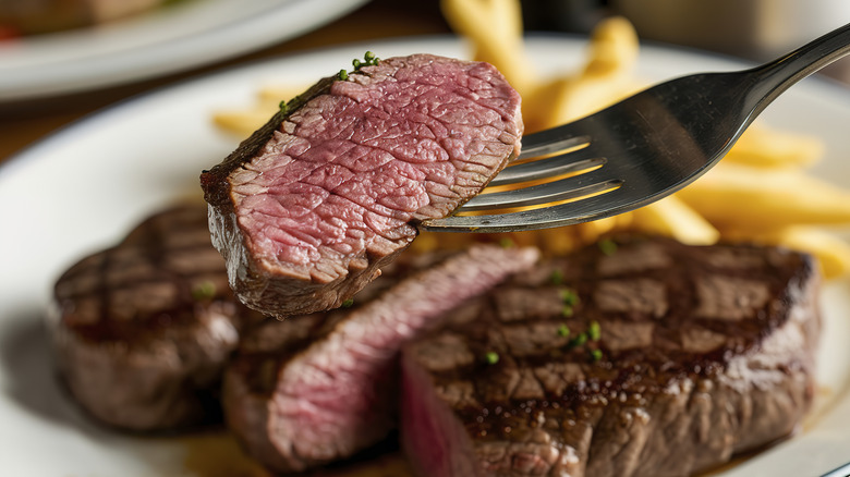 A bite of steak on a fork