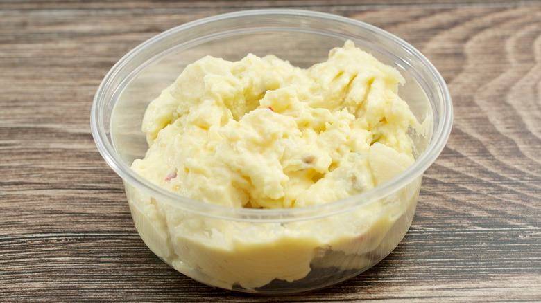 Plastic container of store-bought potato salad
