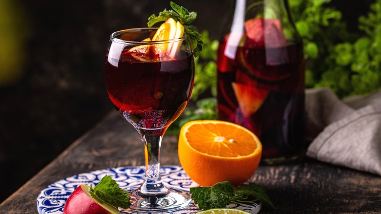 Glass of sangria with fruit inside and around the glass