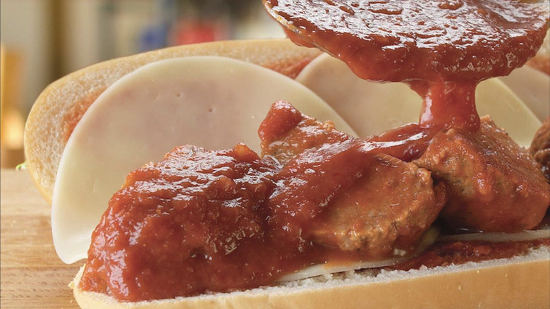 A closeup of marinara sauce drizzling over a Jersey Mike's Meatball Sub