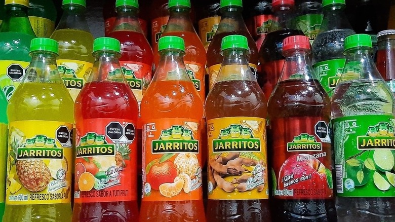 Bottles of Jarritos soda with the different label that's produced by Embotelladora Mexicana