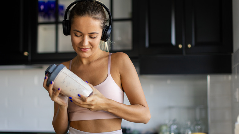 Girl shaking a smoothie cup