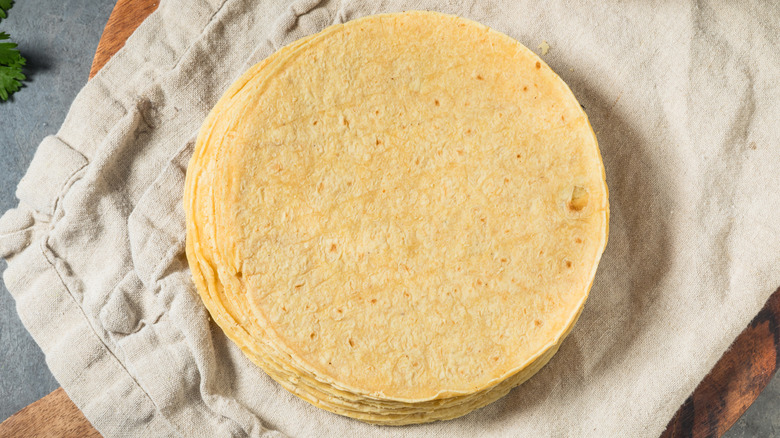 A stack of corn tortillas on a beige towel