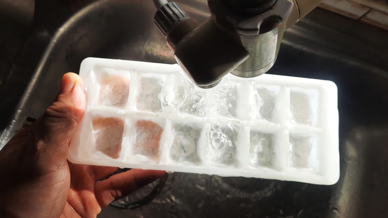 Filling an ice tray with water