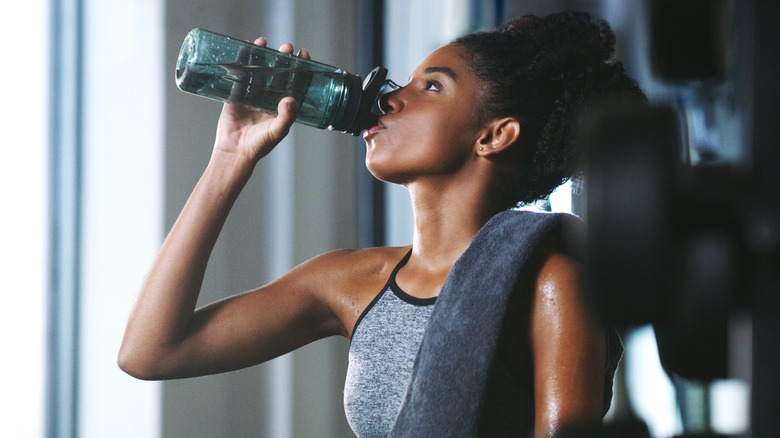 A person drinking water after a workout