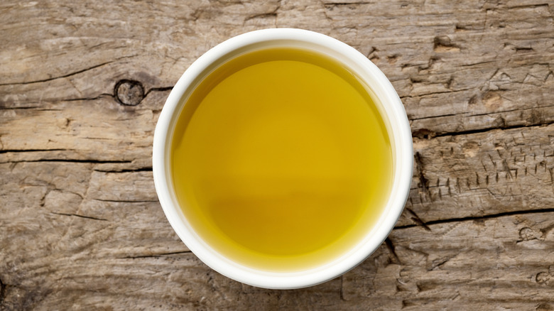olive oil in bowl on wooden surface
