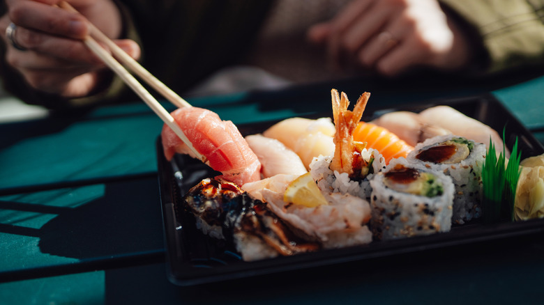 Choosing a piece of sashimi with chopsticks
