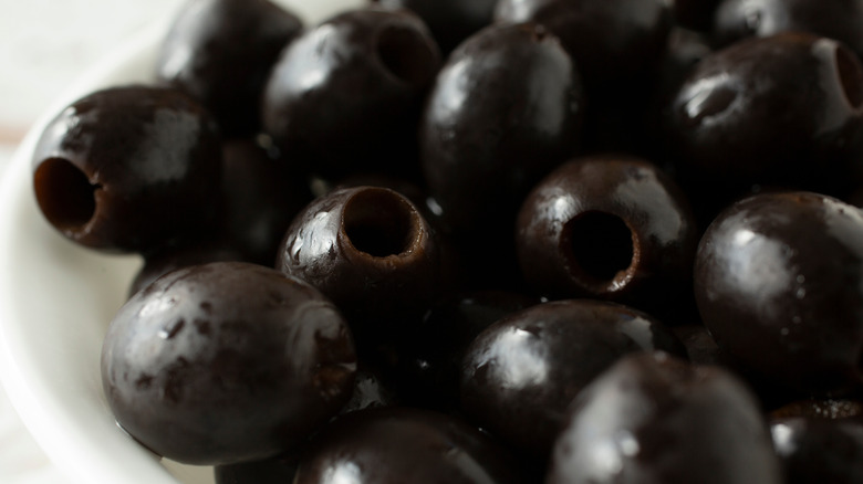 A close-up of canned pitted black olives