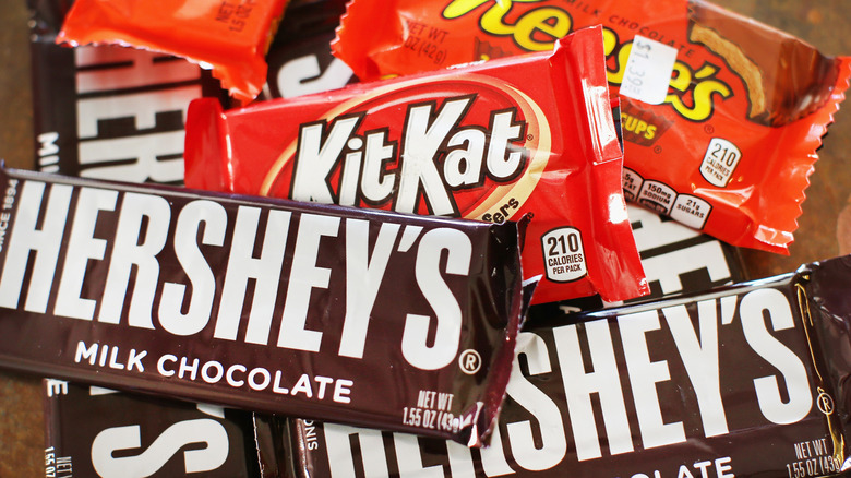 A close up of king-size Hershey's, Kit Kat and Reese's candy bars