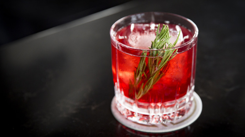A cranberry spritzer in a rocks glass.