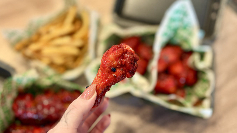 Holding a chicken wing