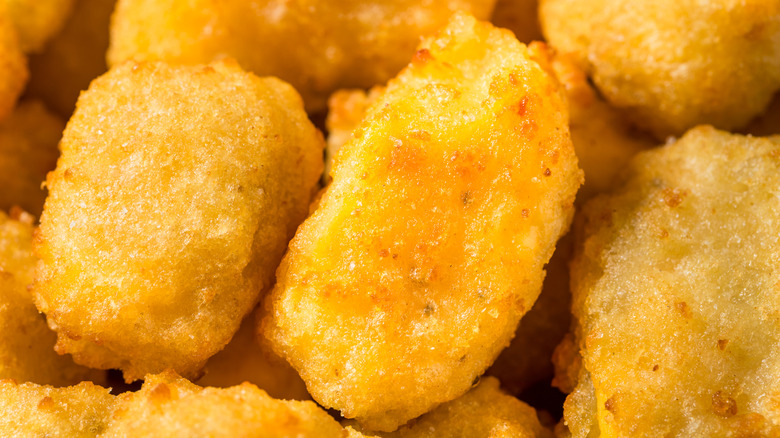 A close up of cheese curds, fried to golden
