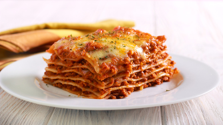 Lasagna cut in a square and sitting on a plate