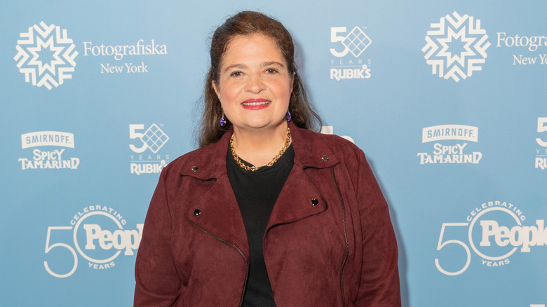 Alex Guarnaschelli smiling at a red carpet event