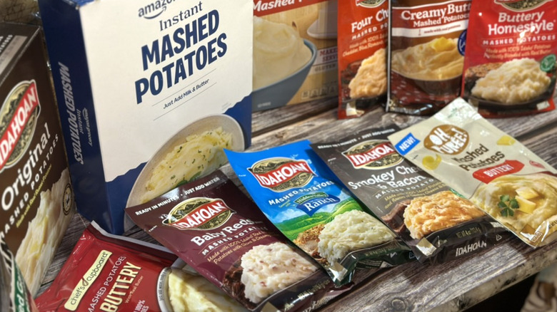 Array of instant mashed potato products on table top.