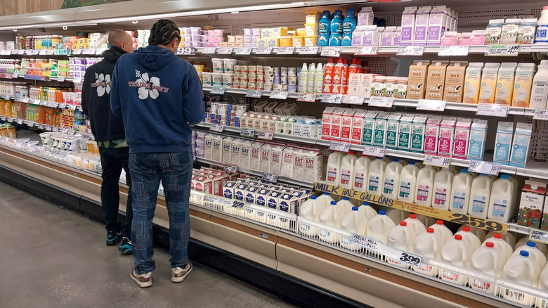 Two men in the dairy aisle of Trader Joe's