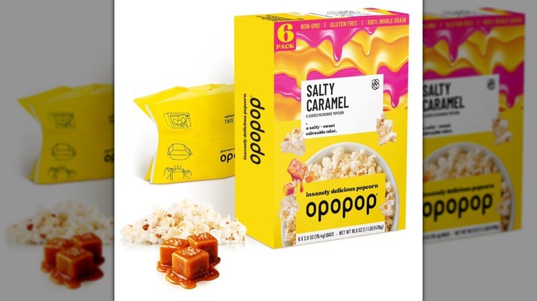 A box and pieces of Salty Caramel Opopop on a white background.