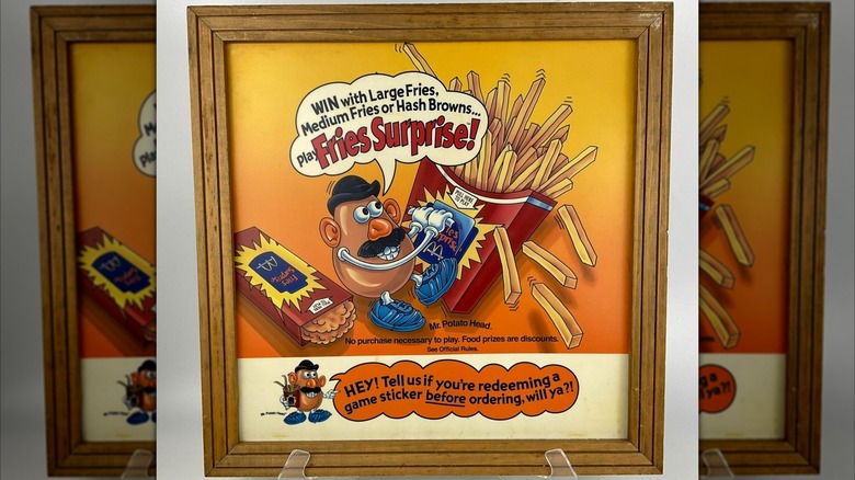 Mr Potato Head on a framed Fries Surprise sign