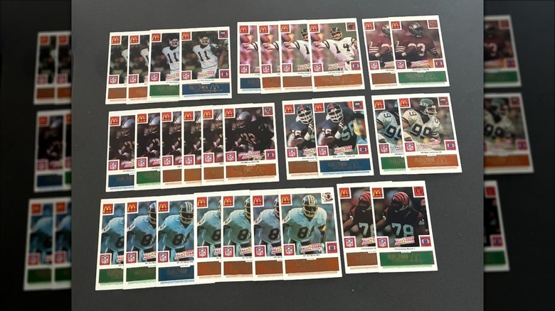 a collection of NFL football cards from McDonald's displayed on a dark background