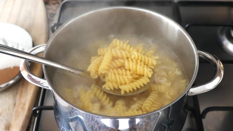 Pasta noodles being boiled in water.