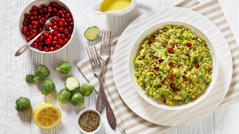 Brussels sprouts slaw alongside fresh cranberries and lemon vinaigrette