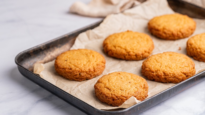 six cookies on a rustic baking tray