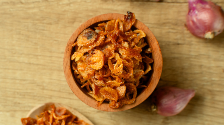 Small wooden bowl of fried shallots