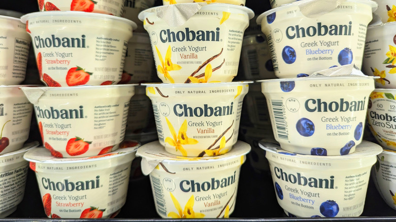 Stacks of Chobani yogurt on a supermarket shelf in three fruit flavors
