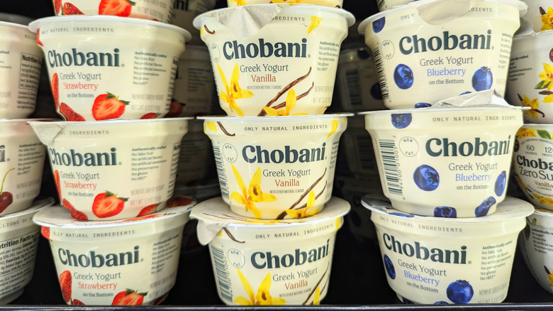 Stacks of Chobani yogurt on a supermarket shelf in three fruit flavors