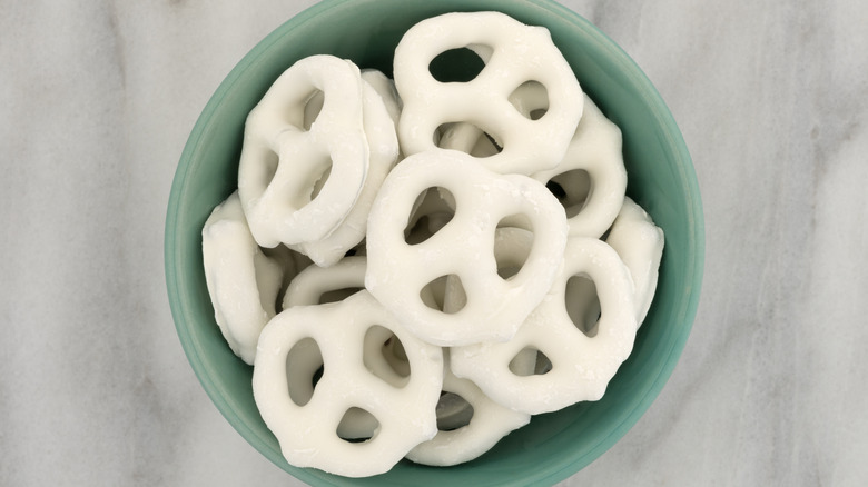 Yogurt-covered pretzels in a green bowl