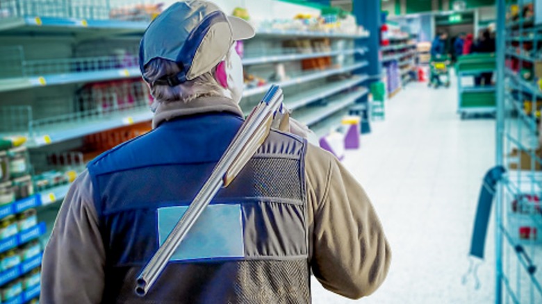 Person walking in store with long gun