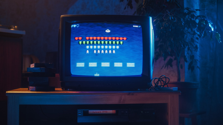 An old tube TV with a retro video game on it