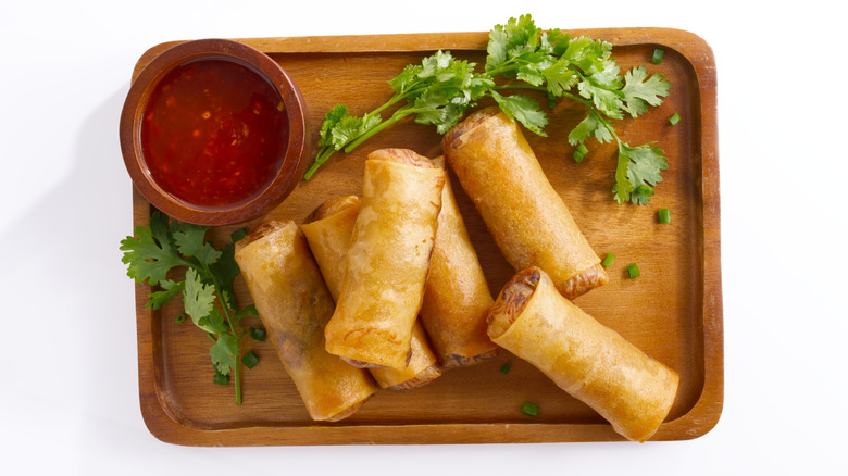 Fried spring rolls and sauce on a platter