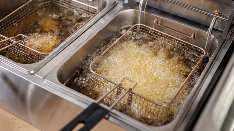 Food deep frying in silver fryers