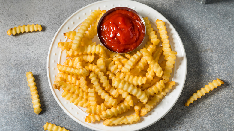 Plate of crinkle-cut fries with a side of ketchup