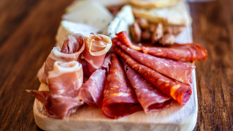 cured meats on a wooden board