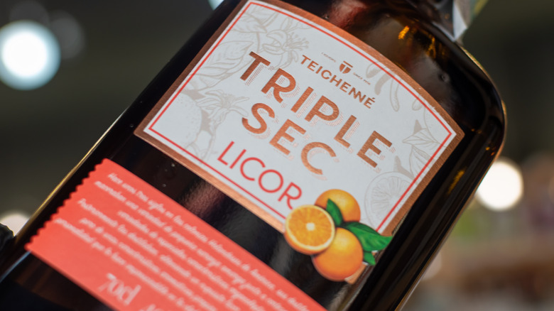 A bottle of Triple Sec licor with oranges on the label.