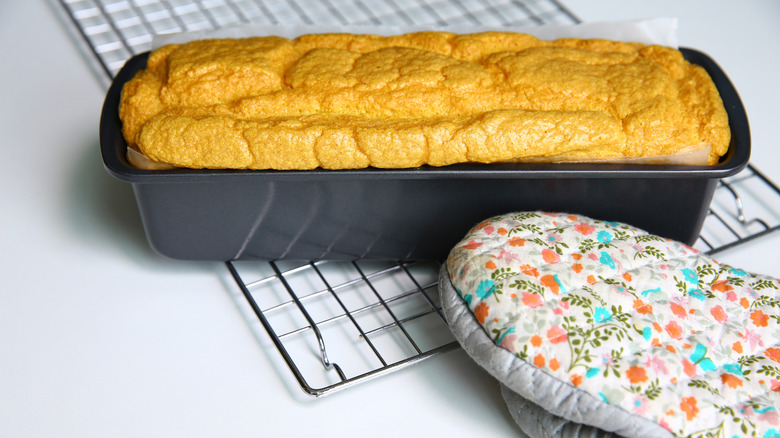 Fluffy bread in a baking pan on a rack