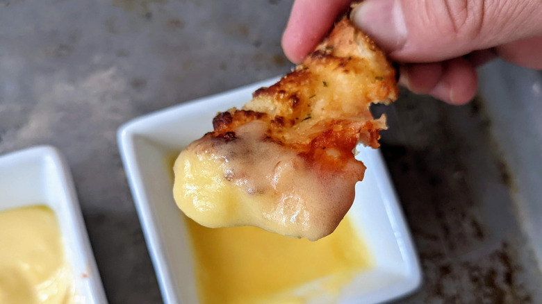 pizza crust dipped in garlic sauce