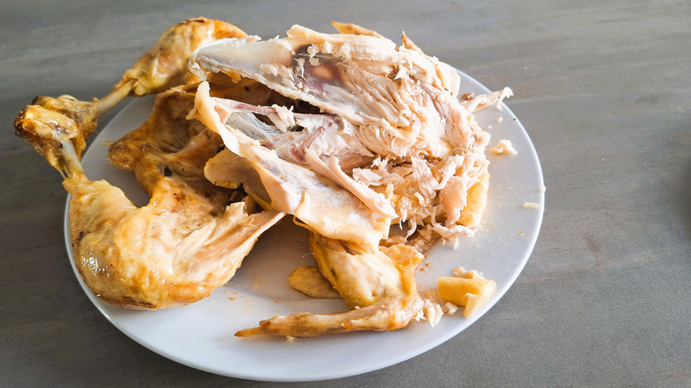 partially carved roast chicken on a plate
