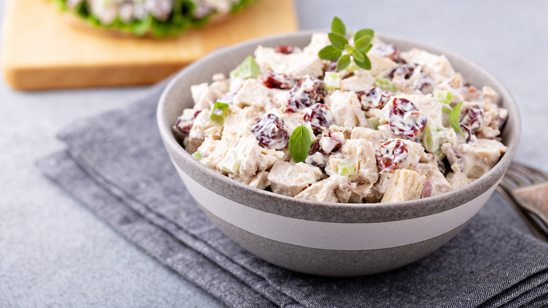chicken salad with fruit in a grey and white bowl