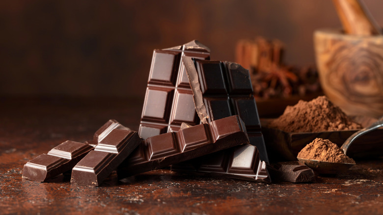 Chocolate bars with cocoa powder and mortar and pestle