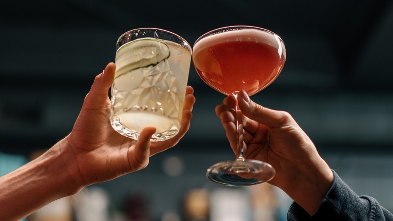 Two people clinking glasses in a bar