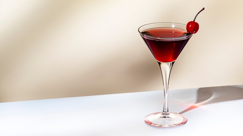 A martini glass filled with a Manhattan