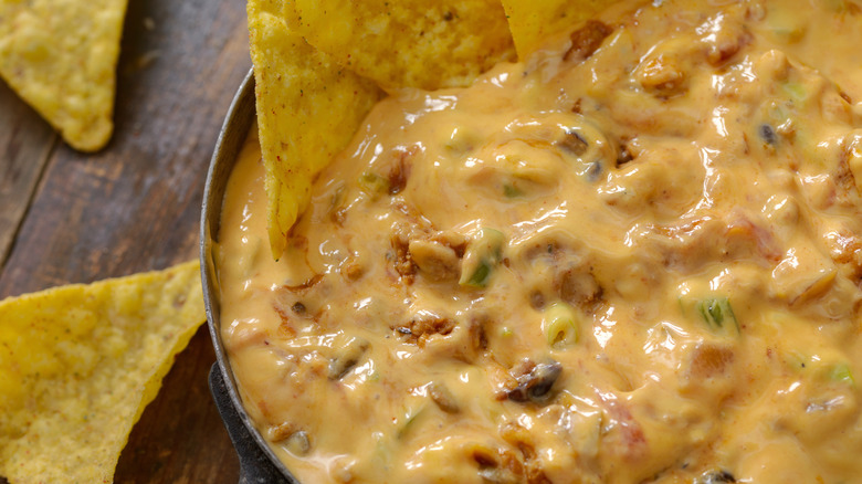 Chili cheese dip with tortilla chips sticking out