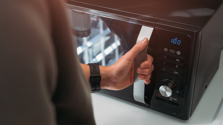 man using microwave