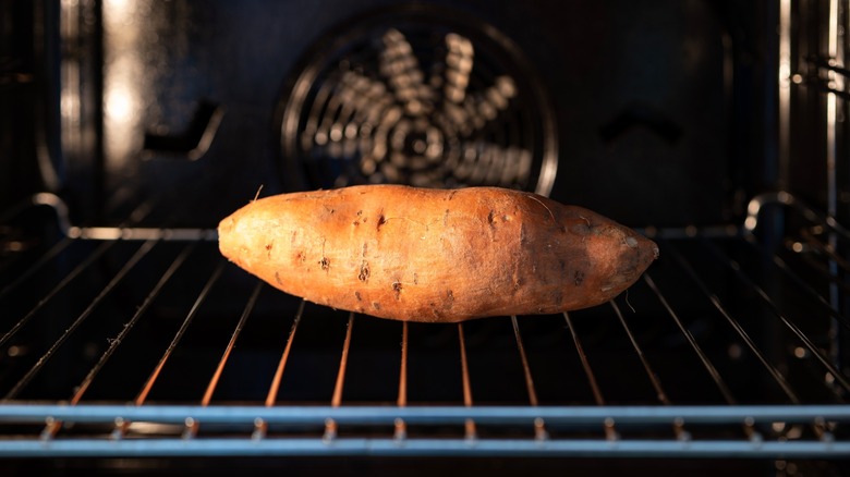 Single sweet potato inside oven