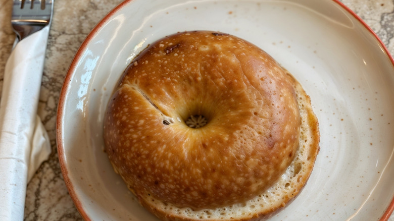 plain bagel on a beige plate